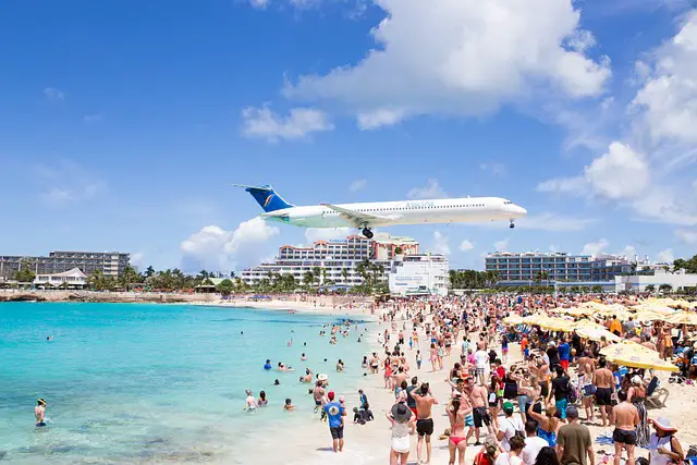 A plane flying over Maho beach in St. Maarten.