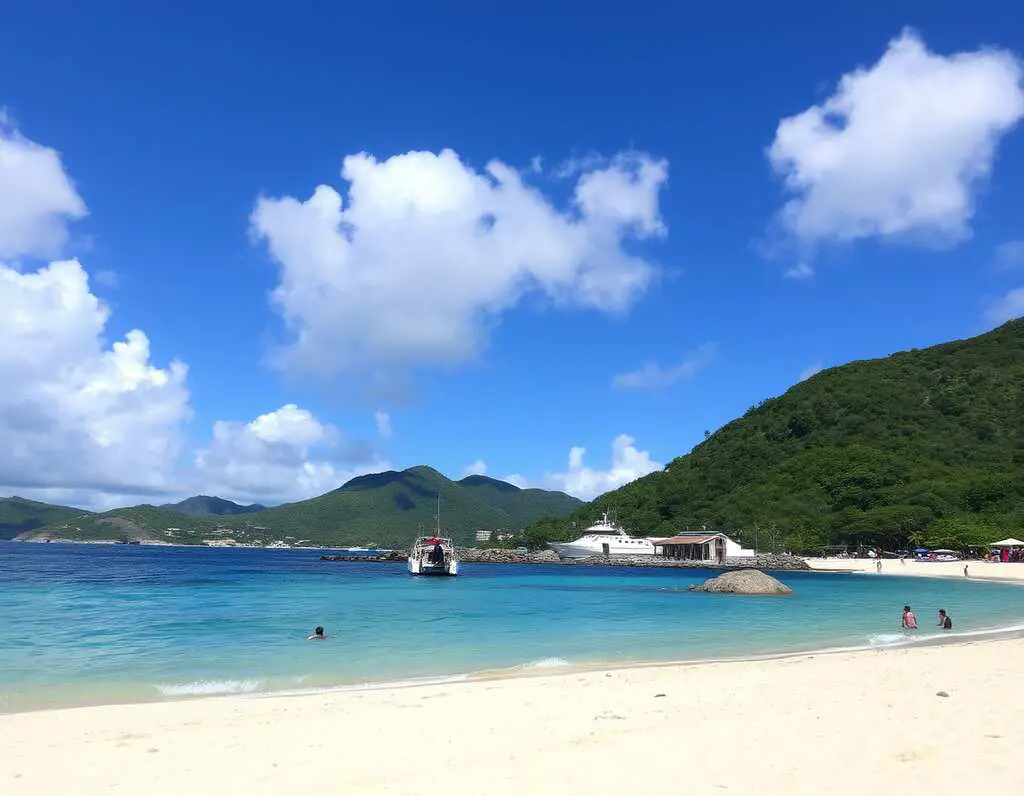 Kim Sha Beach in Sint Maarten with golden sand, calm waters, and beachfront restaurants.